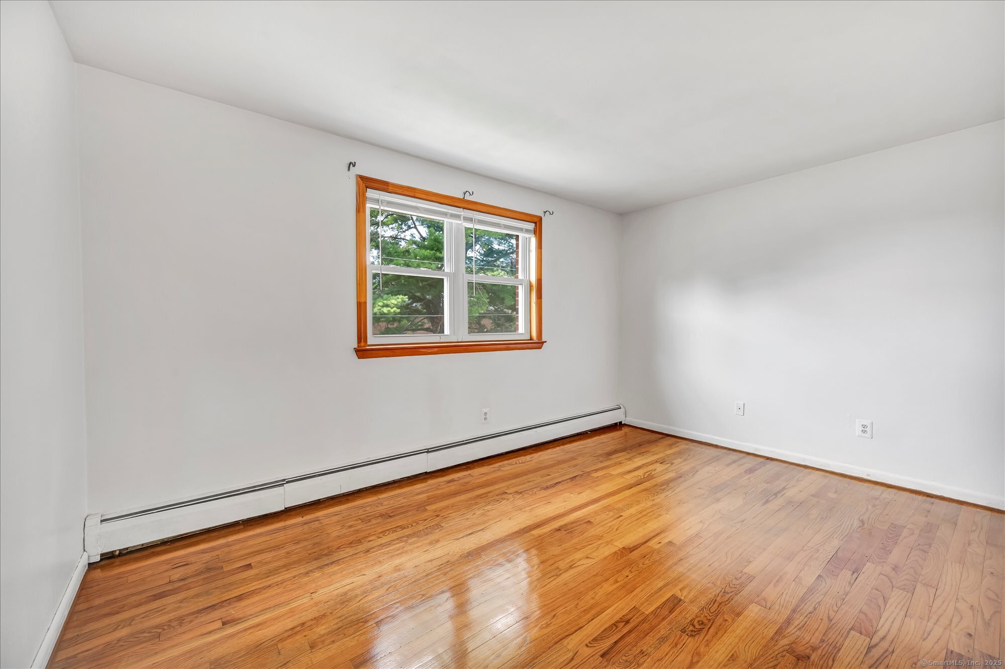 26 Colonial Drive, Unit C Rocky Hill, CT 06067 - Photo 10 of 14 an empty room with wooden floor and windows