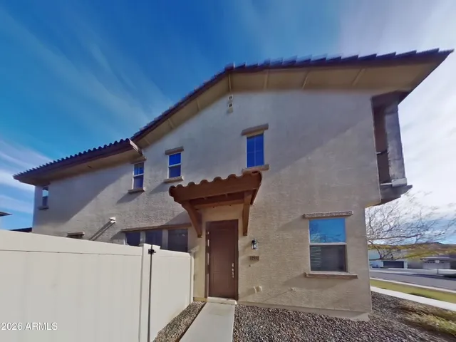 a back view of a house with a yard