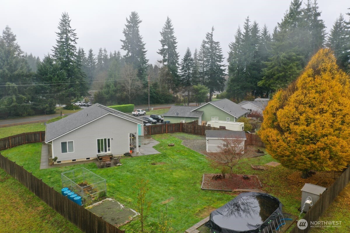 25 Clemons Road Montesano, WA 98563 - Photo 22 of 32 a white house with a small yard and large trees