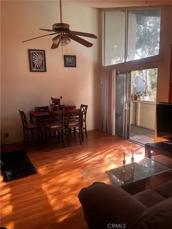 a view of a livingroom with furniture window and wooden floor