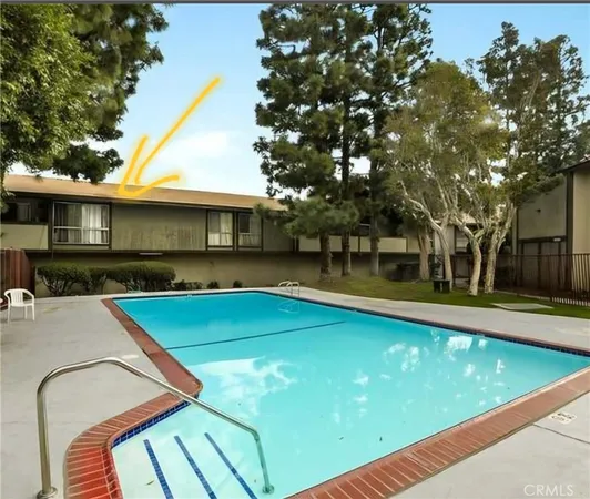 a view of a house with pool and a yard