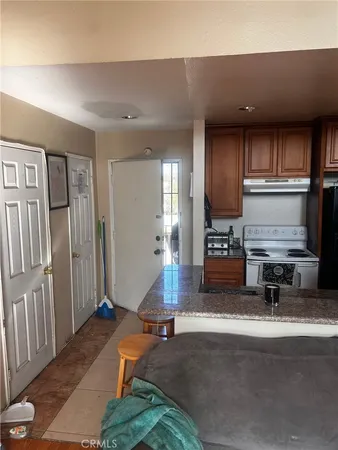 a living room with furniture and kitchen view