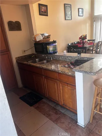 a living room with granite countertop furniture and a potted plant
