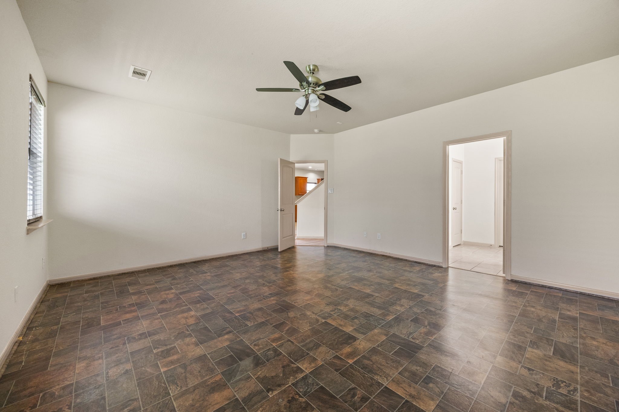 3606 Canvasback Lane Houston, TX 77047 - Photo 15 of 29 Retreat to the oversized primary suite featuring durable tile flooring, abundant space for a sitting area, and direct access to the luxurious ensuite bath.
