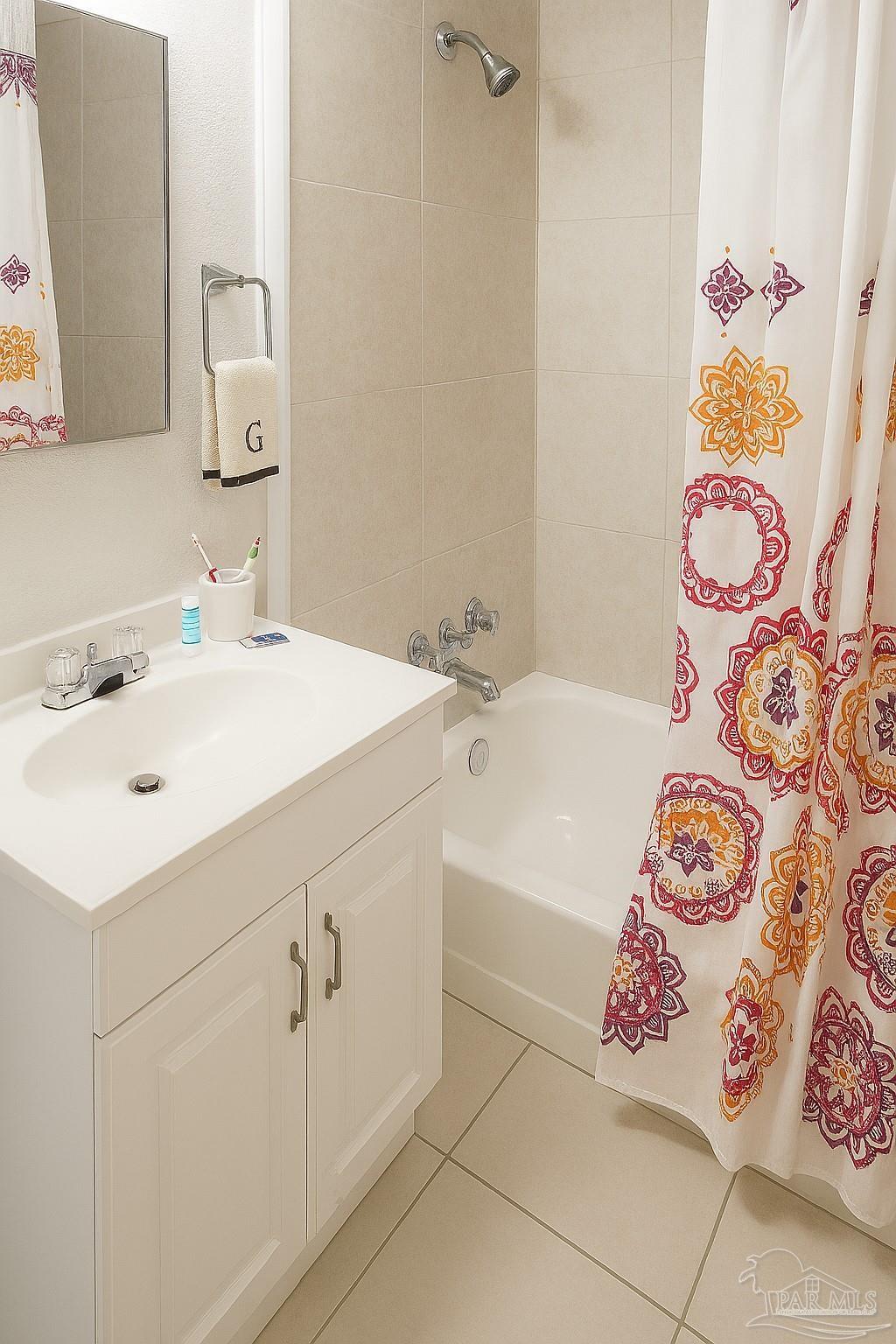 6274 Munson Highway Milton, FL 32570 - Photo 16 of 26 a bathroom with a sink mirror vanity and bathtub