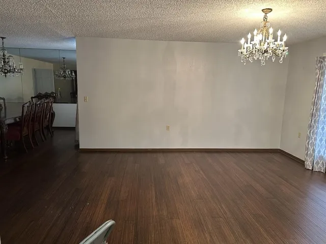 a view of a dining room with furniture wooden floor and chandelier