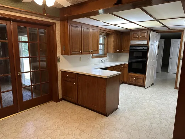 a kitchen with kitchen island a counter top space and stainless steel appliances