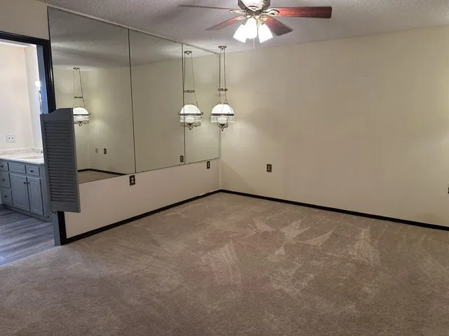 a view of an empty room with a mirror