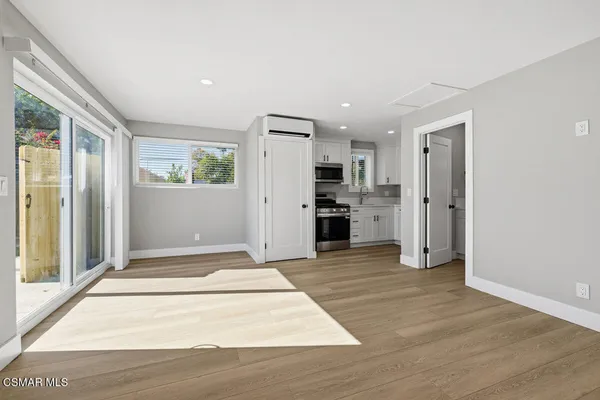 a view of a kitchen with a stove cabinets and wooden floor