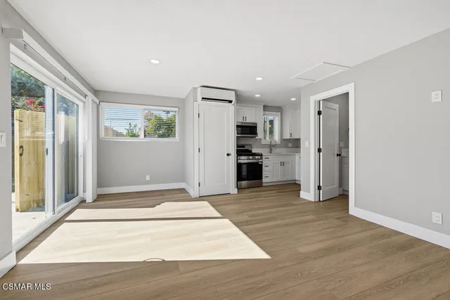 a view of a kitchen with a stove cabinets and wooden floor