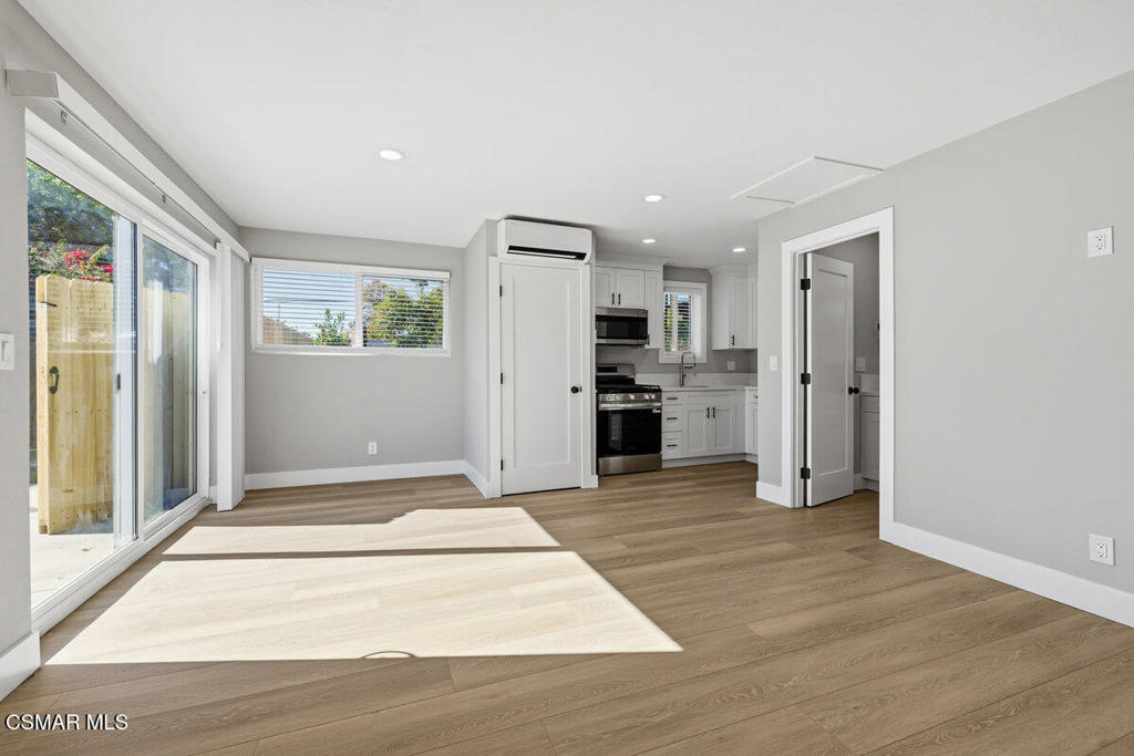 1069 Donner Avenue, Unit B Simi Valley, CA 93065 - Photo 3 of 7 a view of a kitchen with a stove cabinets and wooden floor