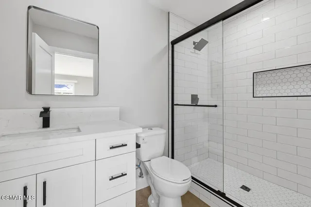 a bathroom with a sink toilet and shower