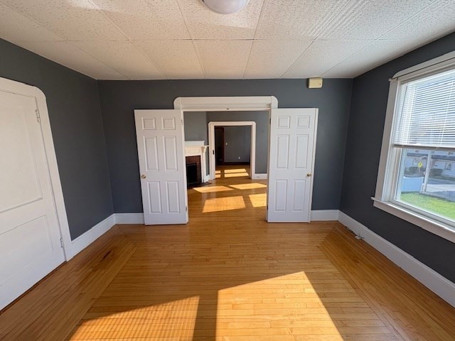 967 Robeson Street, Unit 2 Fall River, MA 02720 - Photo 5 of 15 a view of a room with wooden floor and a window