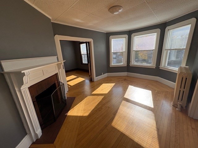 967 Robeson Street, Unit 2 Fall River, MA 02720 - Photo 6 of 15 a view of an empty room with wooden floor and a window