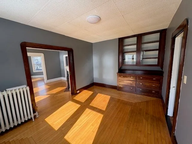 a view of hallway with wooden floor and furniture