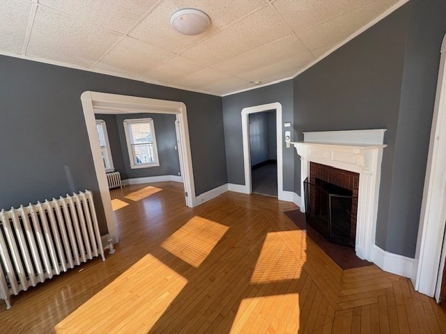 967 Robeson Street, Unit 2 Fall River, MA 02720 - Photo 8 of 15 a bedroom with bed and a fireplace