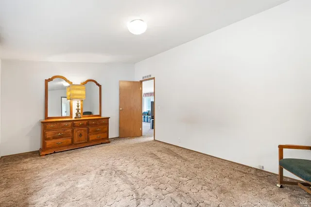 a bedroom with a bed and a dresser