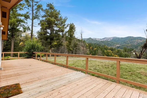 a view of balcony with wooden floor and fence