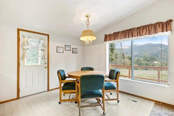 a dining room with furniture and a window