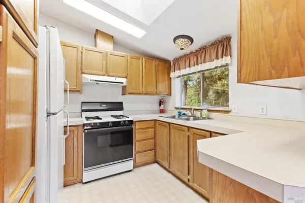 a kitchen with a stove a sink and a refrigerator