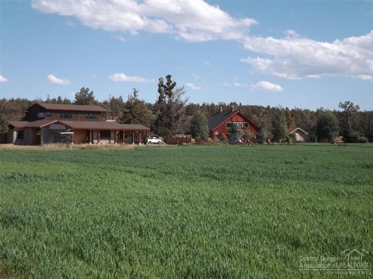 18665 Innes Market Road Bend, OR 97703 - Photo 12 of 23 a view of a house with a big yard and a large tree