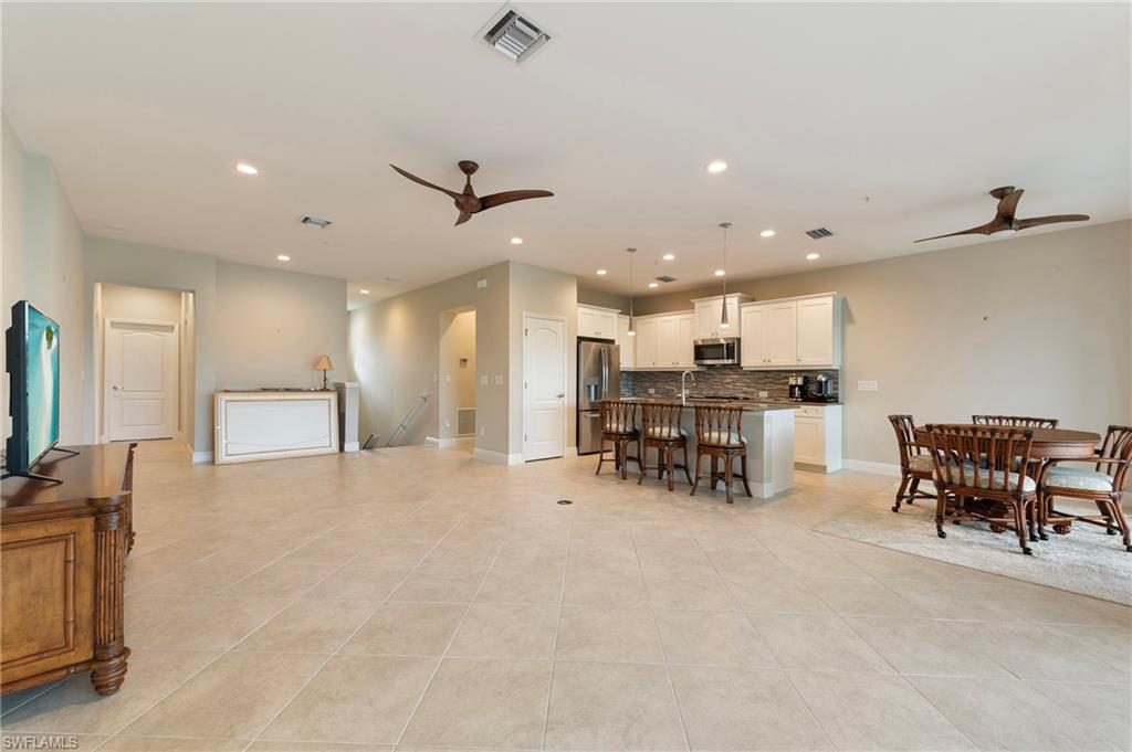 6954 Avalon Circle, Unit 706 Naples, FL 34112 - Photo 7 of 26 a view of kitchen with furniture and a table