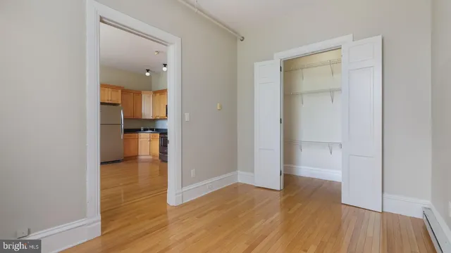 a view of a room with wooden floor and windows