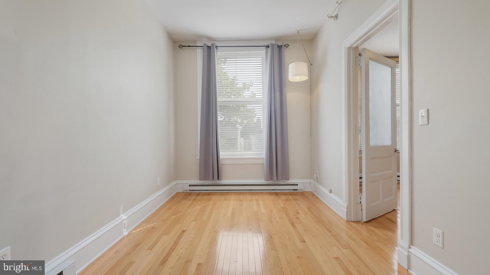 22 North Main Street, Unit 3 Doylestown, PA 18901 - Photo 14 of 18 a view of a room with wooden floor and windows
