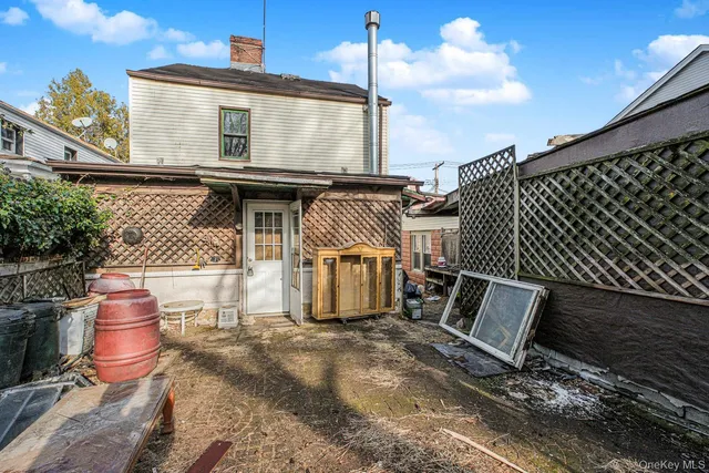 a backyard of a house with table and chairs
