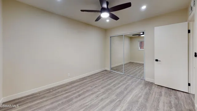 a bathroom with a sink a mirror a toilet and shower