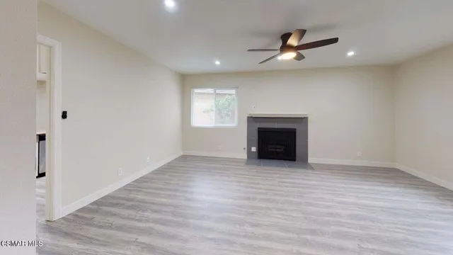 wooden floor in an empty room with a fireplace