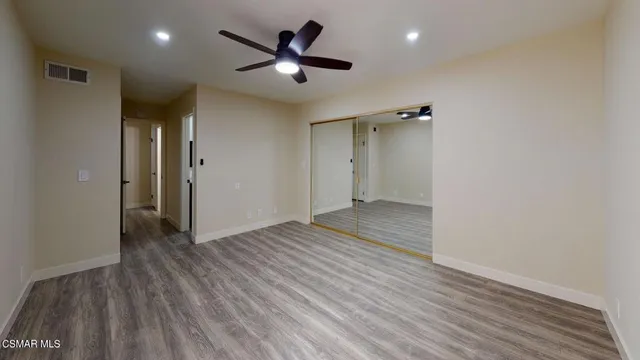 a bathroom with a sink a toilet a mirror and shower