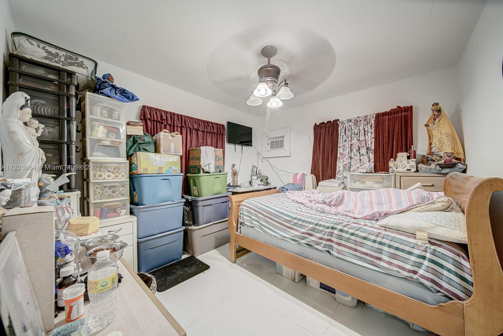 1920 Southwest 4th Street Miami, FL 33135 - Photo 14 of 28 a bedroom with a bed dresser and a table