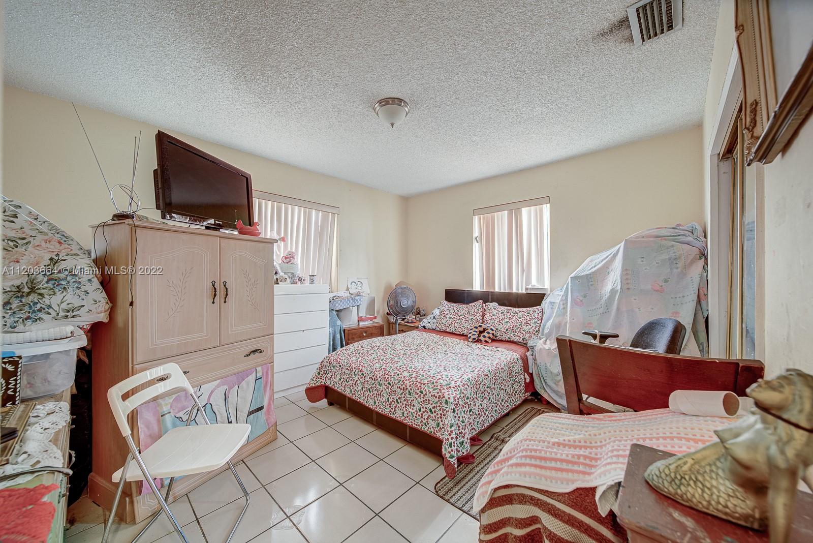 1920 Southwest 4th Street Miami, FL 33135 - Photo 18 of 28 a bedroom with furniture and a flat screen tv