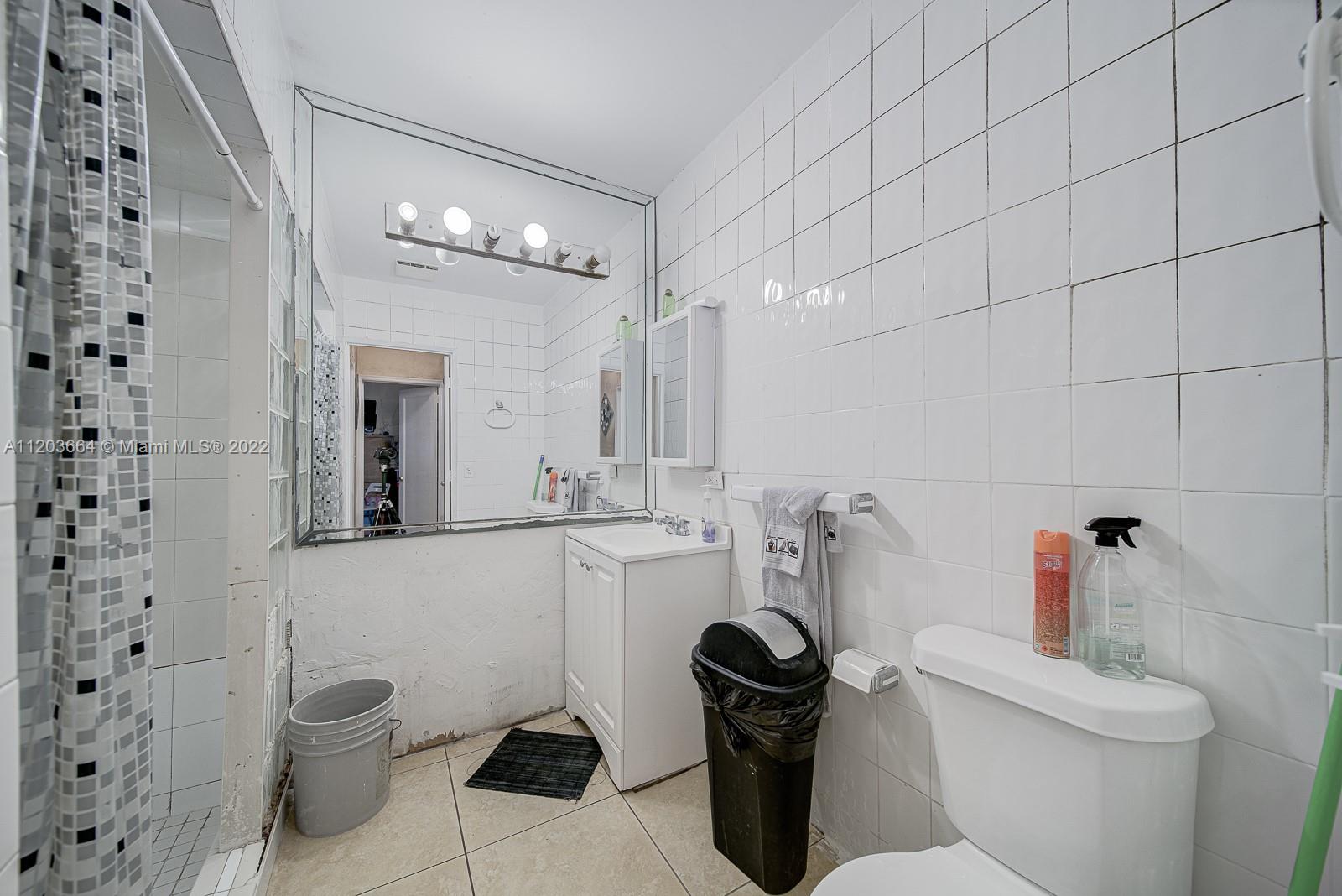 1920 Southwest 4th Street Miami, FL 33135 - Photo 19 of 28 a bathroom with a toilet sink and mirror