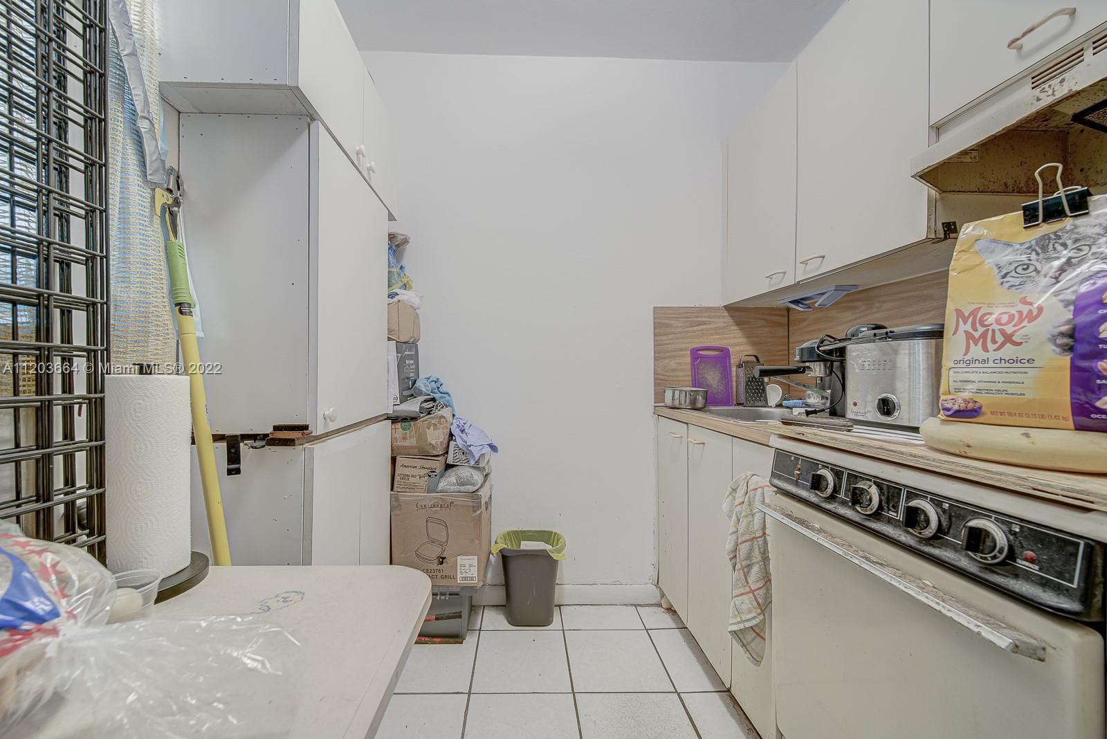 1920 Southwest 4th Street Miami, FL 33135 - Photo 4 of 28 a kitchen with stainless steel appliances a stove and a refrigerator