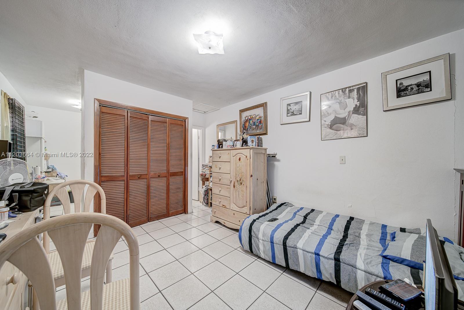 1920 Southwest 4th Street Miami, FL 33135 - Photo 7 of 28 a spacious bedroom with a bed and a desk