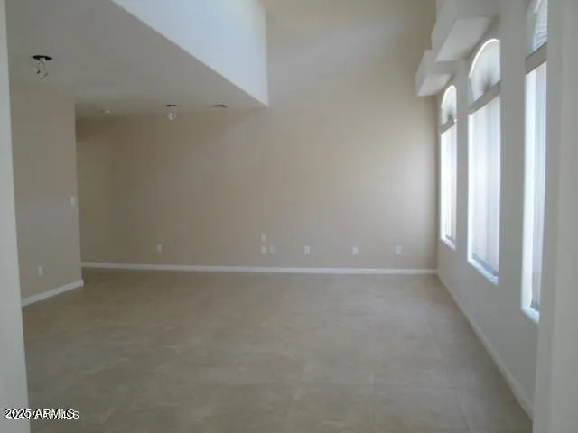 an empty room with windows and bathroom