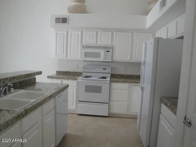 a kitchen with stainless steel appliances granite countertop a sink and cabinets
