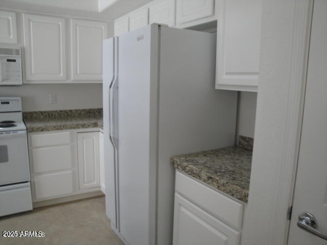7461 West Matilda Lane Glendale, AZ 85308 - Photo 9 of 18 a kitchen with white cabinets and a refrigerator
