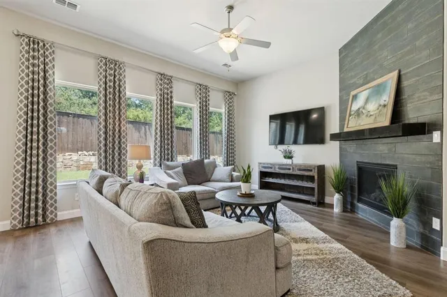 a living room with furniture a fireplace and a flat screen tv