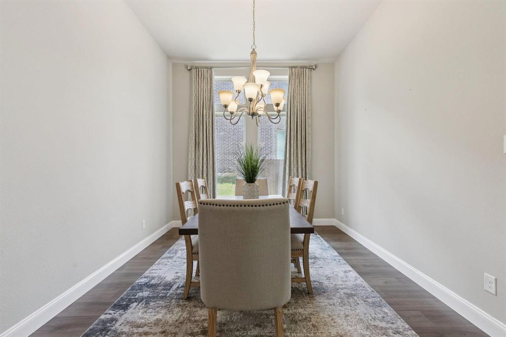 2121 Demarsh Lane Corinth, TX 76210 - Photo 15 of 39 a dining room with chandelier and wooden floor