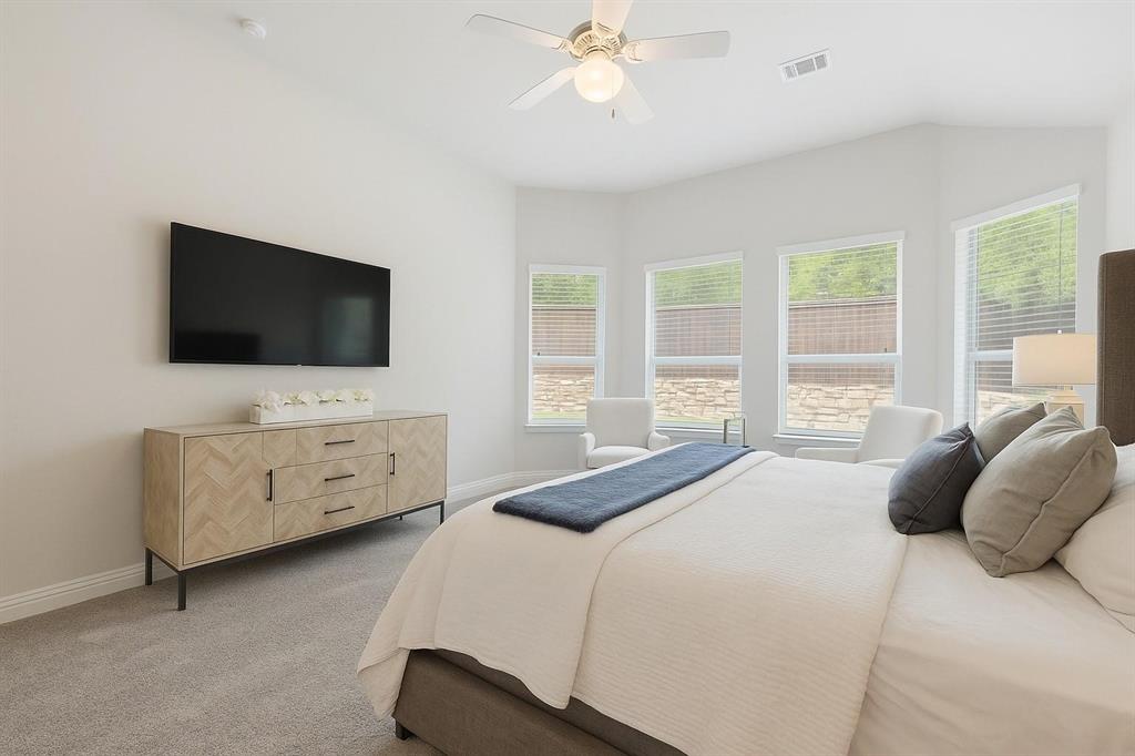 2121 Demarsh Lane Corinth, TX 76210 - Photo 17 of 39 a bedroom with a bed and a flat screen tv