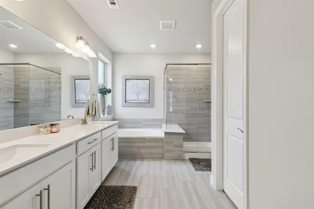 a bathroom with a double vanity sink a toilet and a bathtub