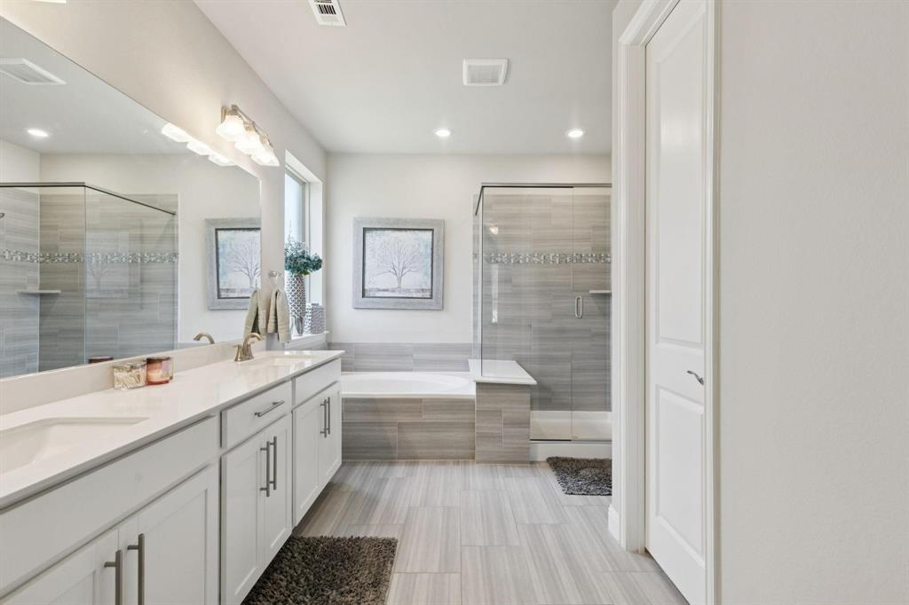 2121 Demarsh Lane Corinth, TX 76210 - Photo 20 of 39 a bathroom with a double vanity sink a toilet and a bathtub