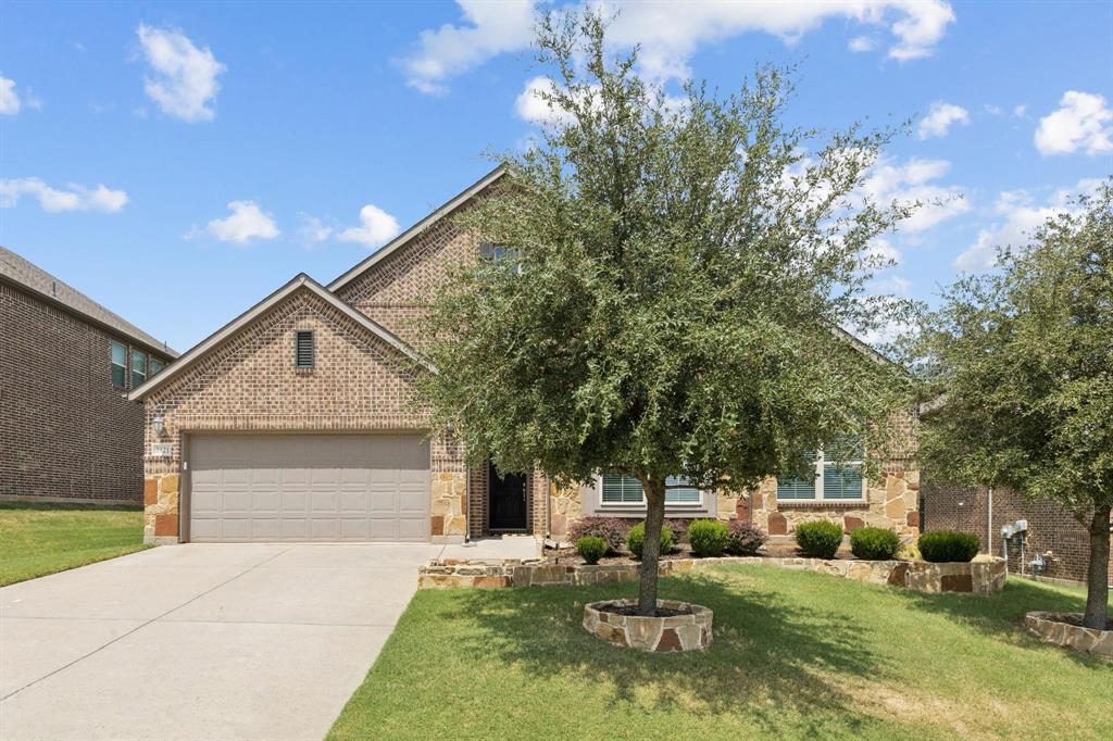2121 Demarsh Lane Corinth, TX 76210 - Photo 2 of 39 a front view of a house with a yard garage and outdoor seating