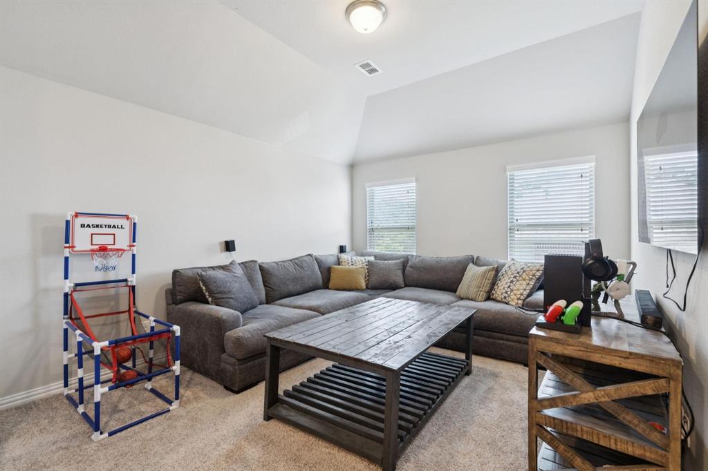 2121 Demarsh Lane Corinth, TX 76210 - Photo 23 of 39 a living room with furniture a rug and a window