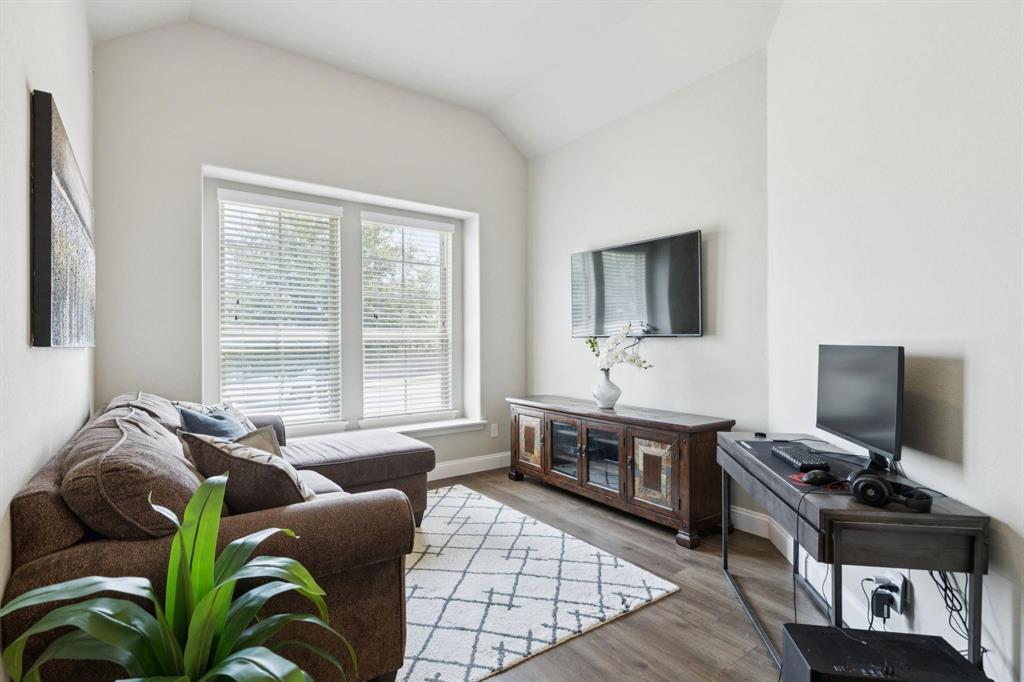 2121 Demarsh Lane Corinth, TX 76210 - Photo 24 of 39 a living room with furniture and a flat screen tv