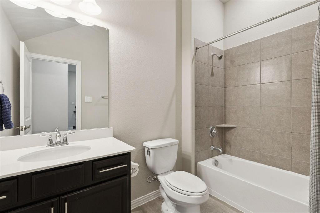 2121 Demarsh Lane Corinth, TX 76210 - Photo 25 of 39 a bathroom with a sink a toilet and a mirror