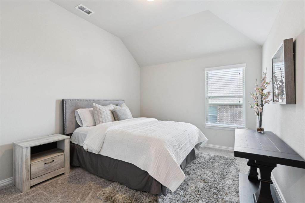 2121 Demarsh Lane Corinth, TX 76210 - Photo 26 of 39 a bedroom with a bed a desk and chair